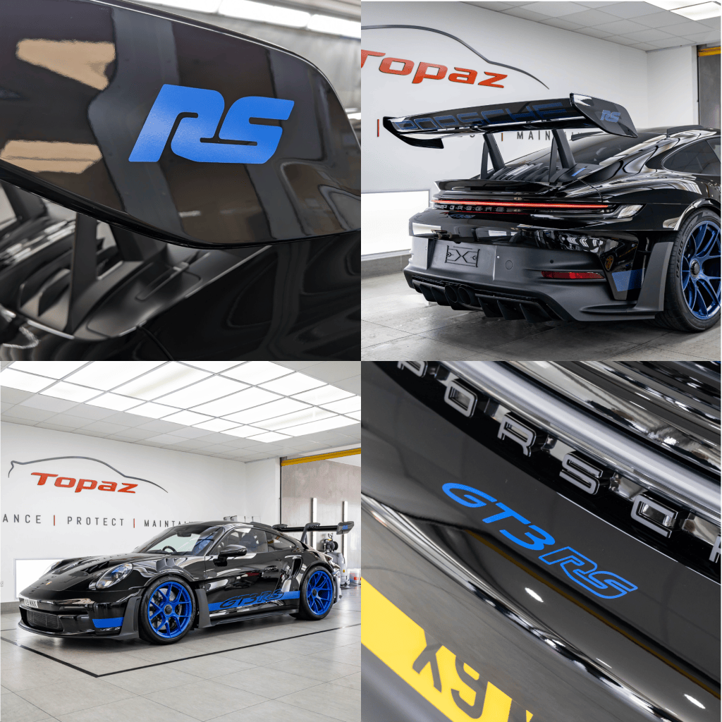 Close-up of a Porsche RS logo on a black car wing.